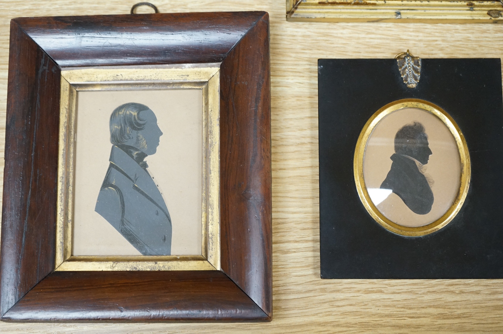 Four early to mid 19th century English School, hand painted silhouette portraits to include a Lady in Regency dress, largest 10 x 7cm. Condition - fair